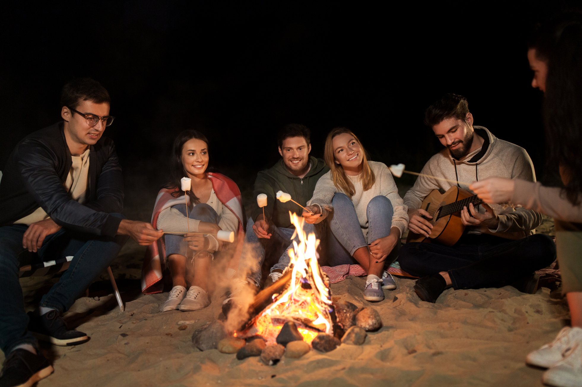 Friends Roasting Marshmallow on Camp Fire at Beach