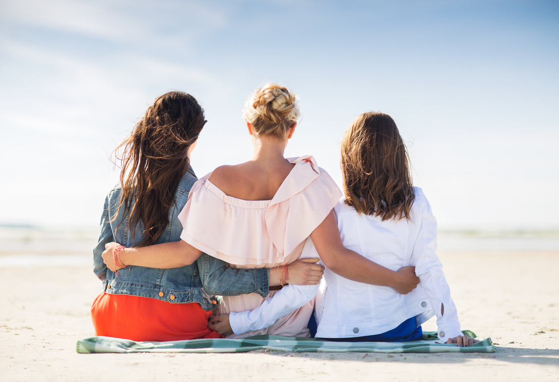 Group of Young Women Hugging on Beach